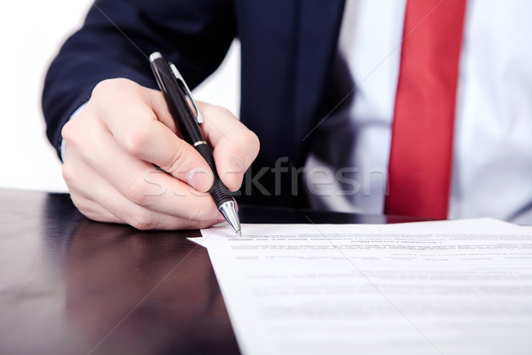 Businessman viewing the contract before signing. Stock photo © traza