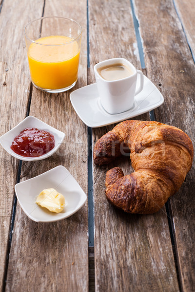 Croissantok dzsúz kontinentális reggeli narancslé feketekávé fa asztal Stock fotó © trexec