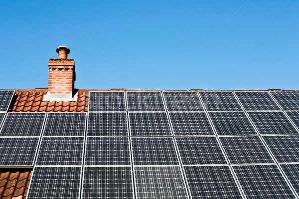 Napelemek modern csempézett tető napfény épület Stock fotó © trgowanlock
