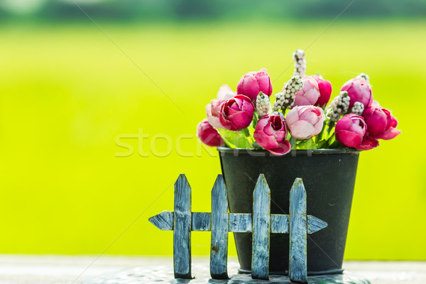 old dirty fake rose on wood table Stock photo © tungphoto