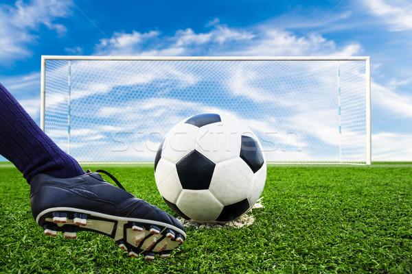 Stock photo: foot kicking soccer ball