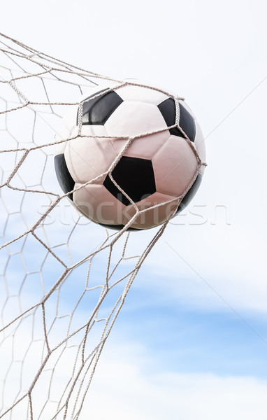 Stock photo: soccer ball in goal net