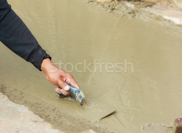hand pastering cement mortal on the floor Stock photo © tungphoto
