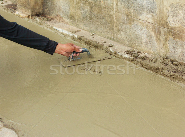 hand pastering cement mortal on the floor Stock photo © tungphoto
