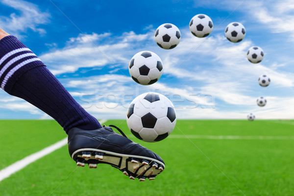 Stock photo: foot kicking soccer ball