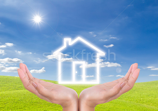 House icon on hand Stock photo © tungphoto