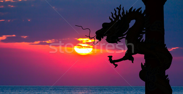 Dragon silhouette and sunset in the sea Stock photo © tungphoto
