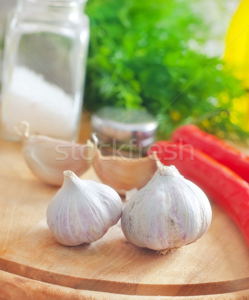 Fresh garlic and aroma spice on the wooden board Stock photo © tycoon