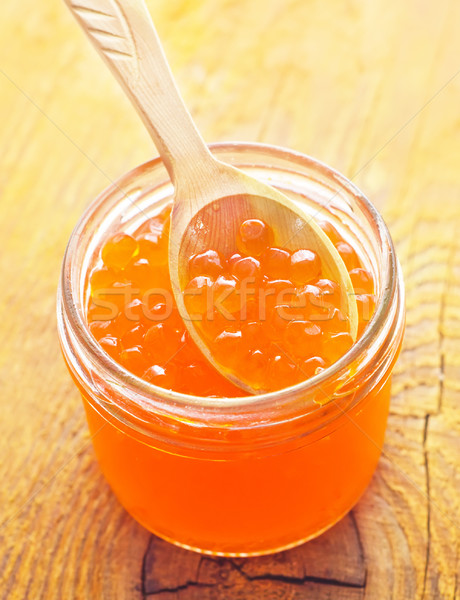 Red salmon caviar in the wooden bowl and spoon Stock photo © tycoon