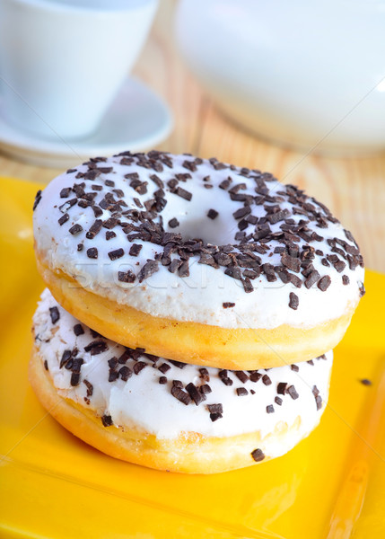 Delicious doughnuts on the yellow plate, donuts with chocolate Stock photo © tycoon