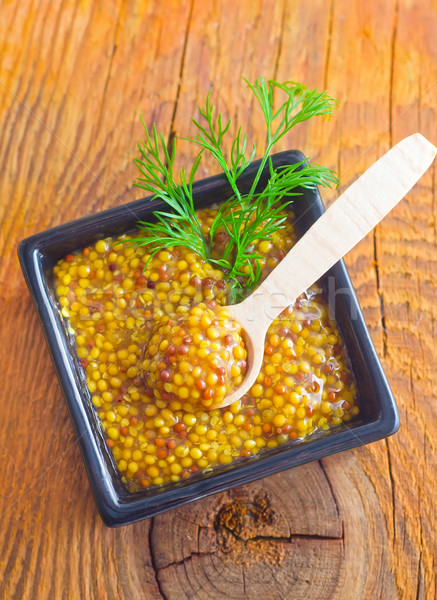 Mustard in the black bowl on table Stock photo © tycoon
