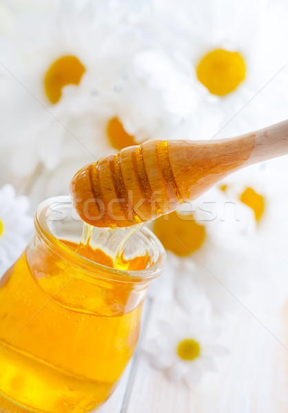 fresh honey in the glass bank and camomiles Stock photo © tycoon