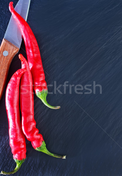 Chilli piros forró paprikák fekete asztal Stock fotó © tycoon