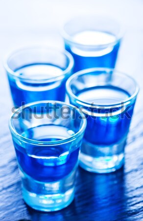 Kék alkoholos ital kicsi szemüveg asztal kéz Stock fotó © tycoon