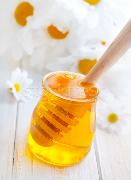 fresh honey in the glass bank and camomiles Stock photo © tycoon