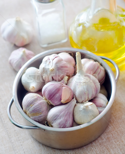 Stock photo: garlic in metal bowl on the table