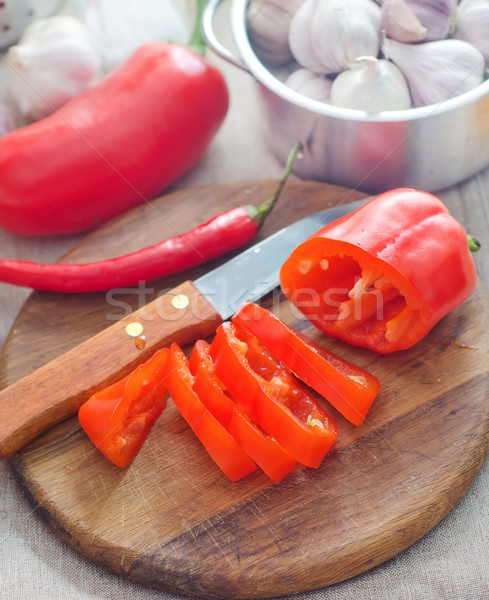 Raw red peppers on the wooden board Stock photo © tycoon