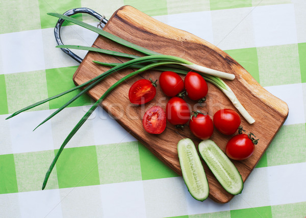 red tomatoes and green onions on cutting board closeup Stock photo © ultrapro