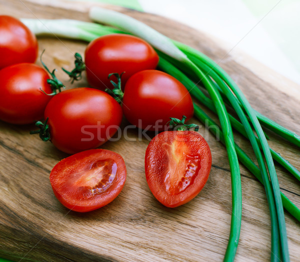 red tomatoes and green onions on the cutting board Stock photo © ultrapro