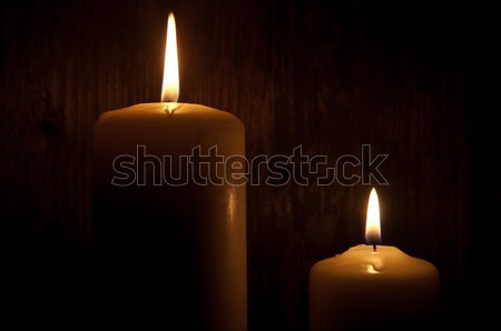 Stock photo: Lit candles in the dark 