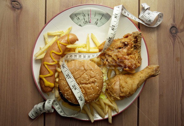 Junk food diet weighing scales  Stock photo © unikpix