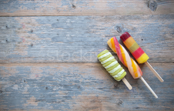 Stock photo: Ice lollies on a wooden backgroud