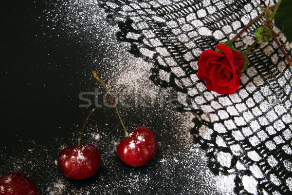 Sweet cherry against black background,  lacy drawing from icing  Stock photo © user_11056481