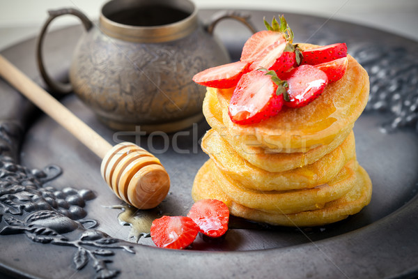 Stack of sweet pancakes with strawberry and honey. Stock photo © user_11224430