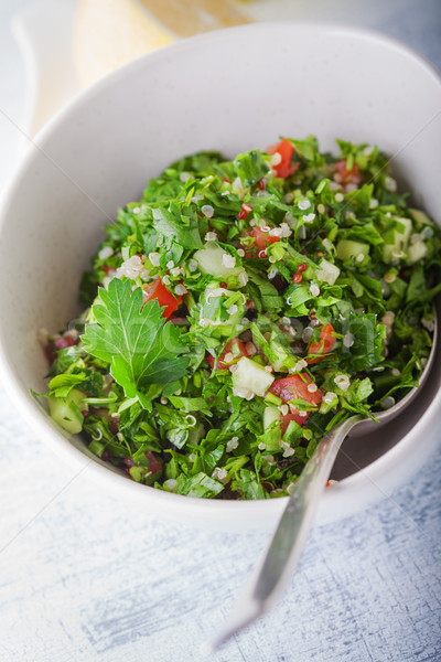 Quinoa tabbouleh salad on a wooden table Stock photo © user_11224430