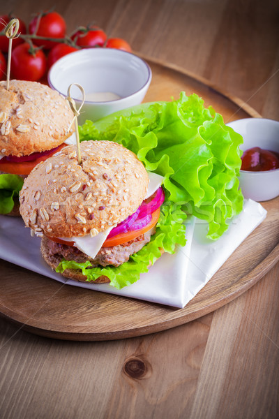 Cheeseburger with salad, onion, tomato and fresh bread. Stock photo © user_11224430