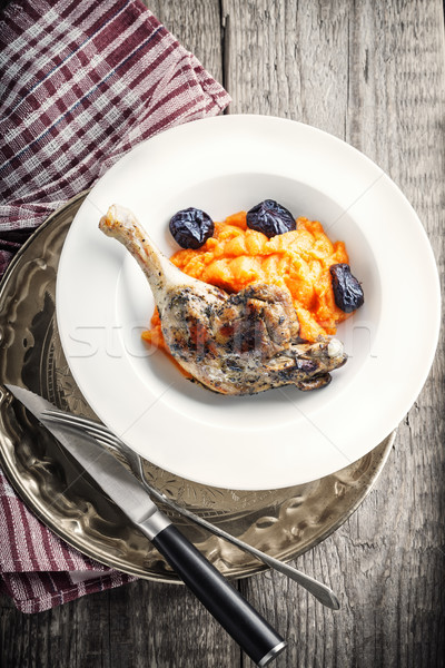 Roasted duck leg with mashed carrot and dried prunes Stock photo © user_11224430