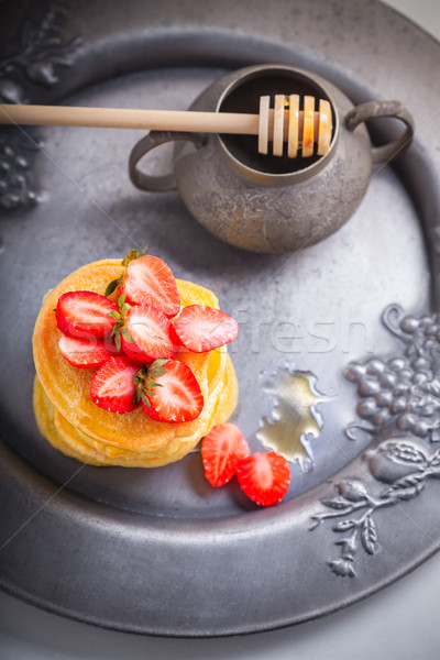 Stock photo: Stack of sweet pancakes with strawberry and honey.