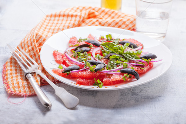 Grapefruit salad with olives, red onion, basil Stock photo © user_11224430