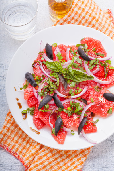 Grapefruit salad with olives, red onion, basil Stock photo © user_11224430