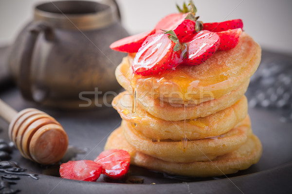 Stack of sweet pancakes with strawberry and honey. Stock photo © user_11224430