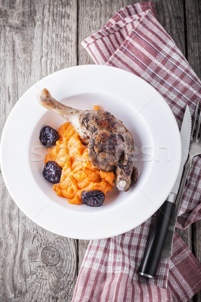 Roasted duck leg with mashed carrot and dried prunes Stock photo © user_11224430