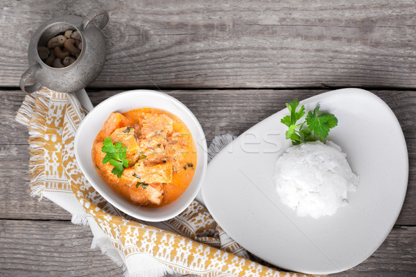 Chicken curry and rice served on a wooden surface. Stock photo © user_11224430