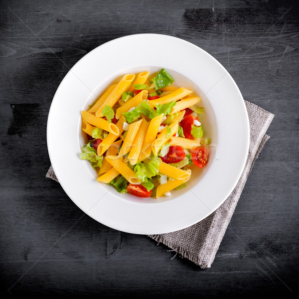 Stock photo: Penne pasta salad with fresh tomato and salad.