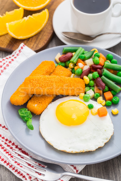 Fish sticks, fried egg and vegetables Stock photo © vankad