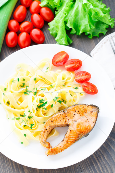 Delicious fettuccini with fried salmon Stock photo © vankad