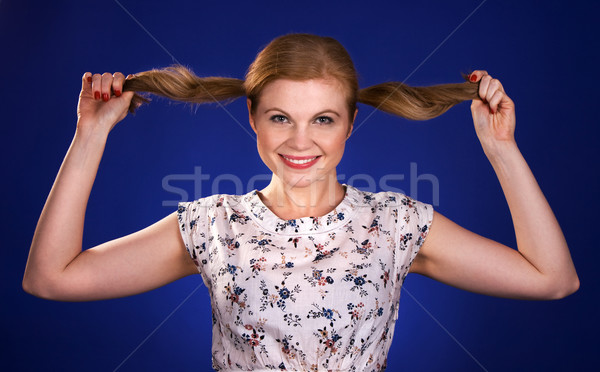 Beautiful red head woman holding her ponytails Stock photo © vankad