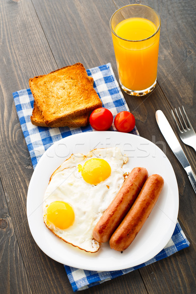 Stock photo: Fried eggs with sausages.