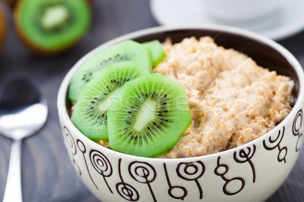 Bowl of oats porridge with kiwi Stock photo © vankad