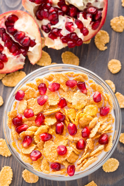 Stock photo: Sugar coated corn flakes with milk and pomegranate