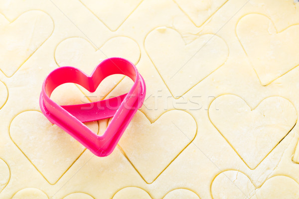 Heart shaped cookie cutter on raw dough Stock photo © vankad