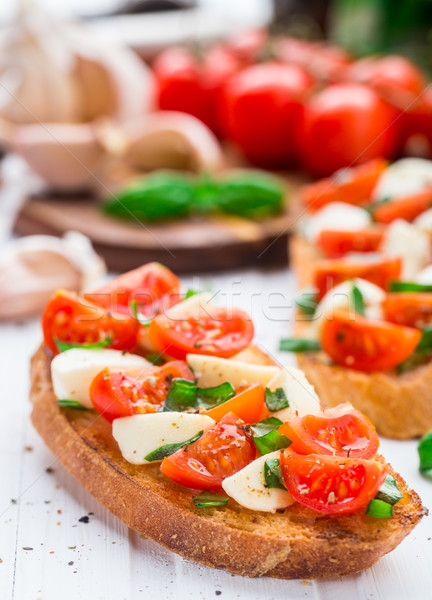Bruschetta with cherry tomato and mozzarella Stock photo © vankad