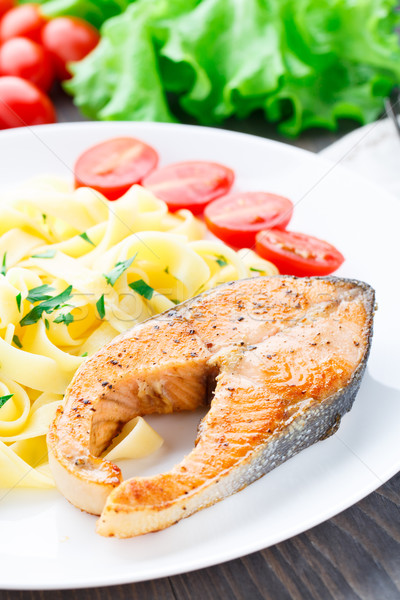 Delicious fettuccini with fried salmon Stock photo © vankad