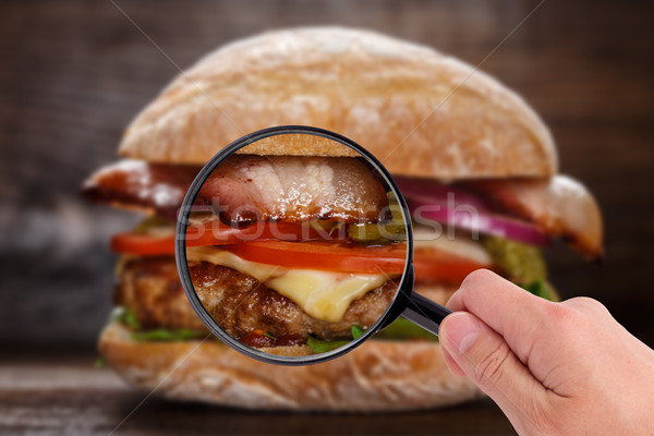 Magnifying glass examining burger  Stock photo © vankad