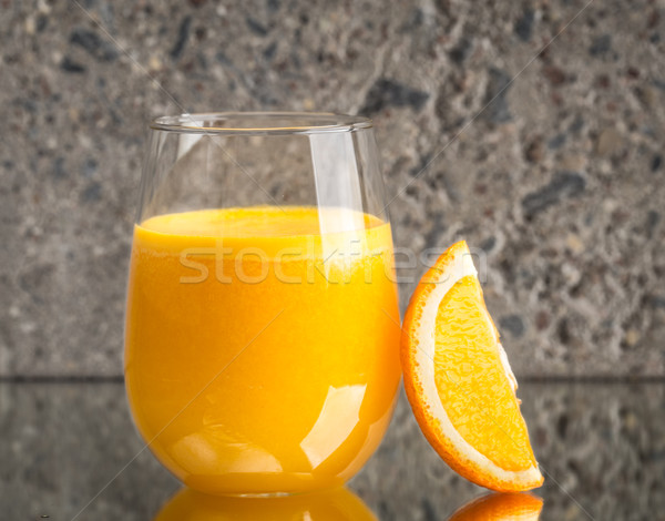 Glass of fresh orange juice on concrete background Stock photo © vankad