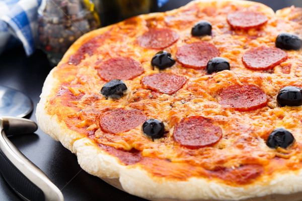 Délicieux pepperoni pizza olives noir table [[stock_photo]] © vankad